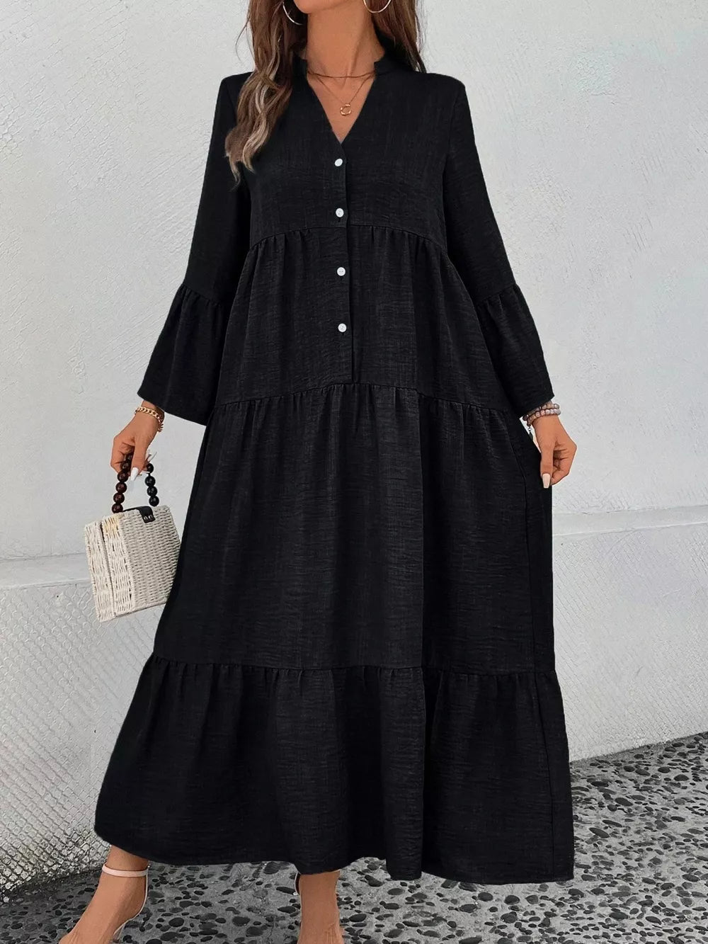 Black tiered ruffle hem v-neck dress with button front and bell sleeves.