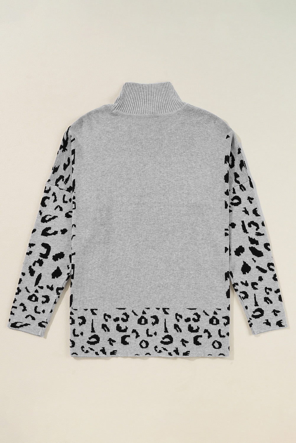 Gray turtleneck sweater with asymmetric leopard print sleeves and hem