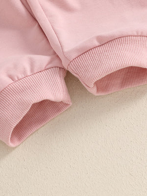 Pink cotton baby outfit set with ribbed cuffs and hem detail.