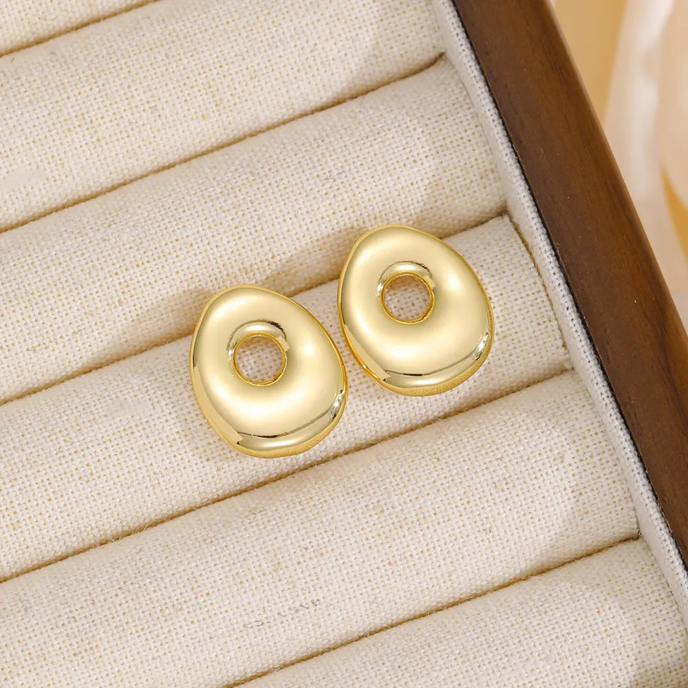 Alphabetical sculpted stud earrings in gold tone copper, abstract bubble shape.