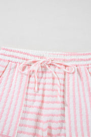 Textured stripe lounge shorts in blush pink and white with drawstring waist.