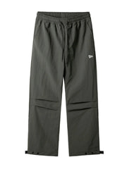 Dark gray utility joggers with drawstring waist, cargo pockets, and adjustable ankle cuffs.