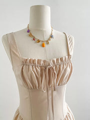 Elegant Square Neck A-line Maxi Dress in beige with ruched bodice and tie detail.