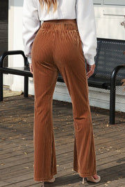 Velvet corduroy palazzo trousers in caramel with a high elastic waist and flared leg.