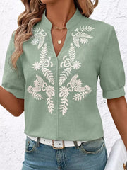 Green embroidered notched blouse with cuffed sleeves and V-neck.