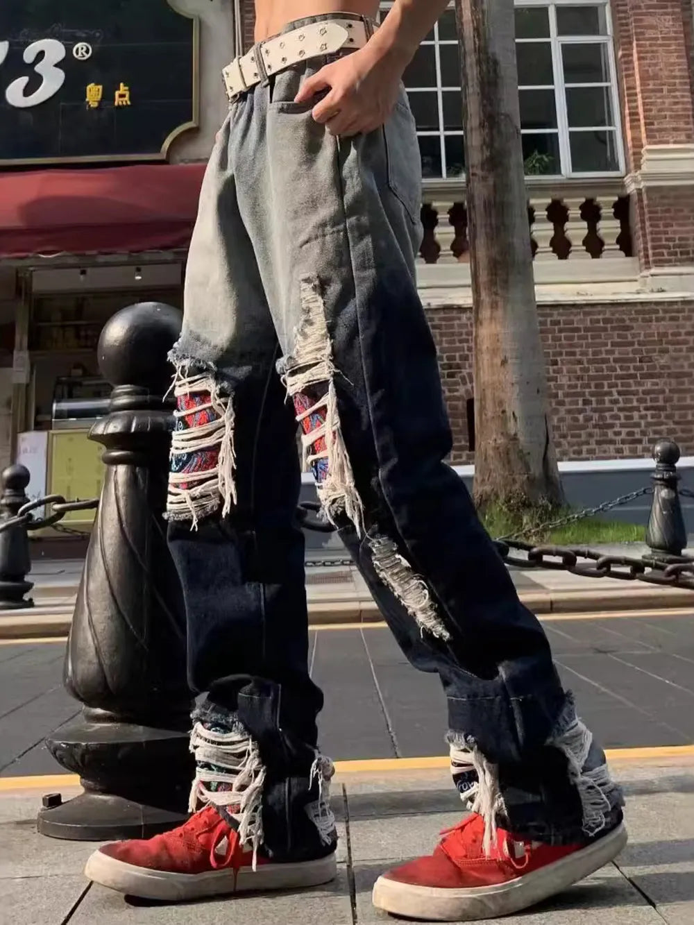 Two-tone distressed loose fit jeans with ripped details and frayed hems.