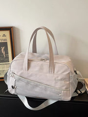 Grey nylon travel organizer bag with adjustable strap and mesh pocket details.