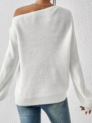 White asymmetrical knit sweater with off-shoulder neckline and long sleeves.