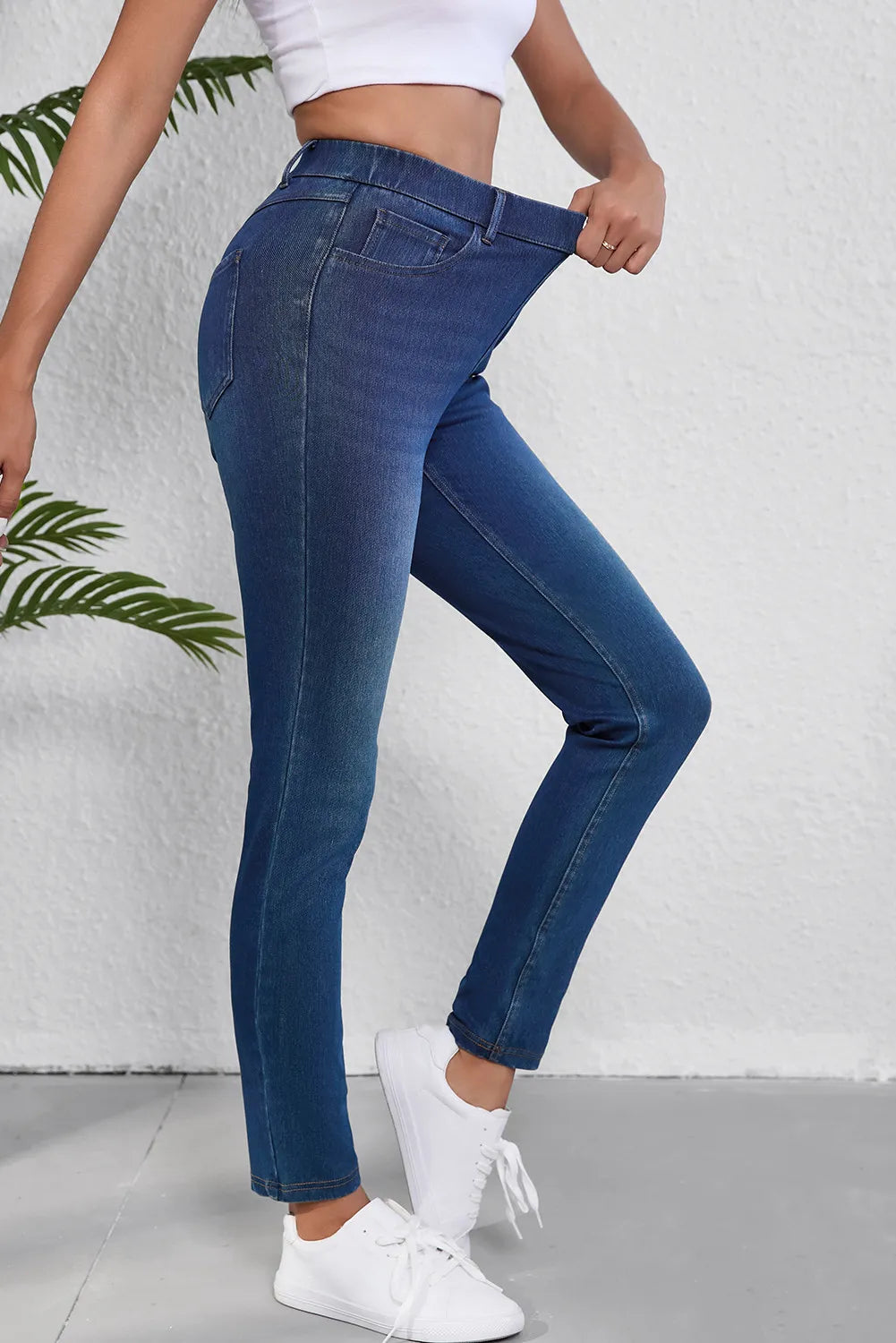 Medium wash denim pull-on jeans with a high waist and slim fit.
