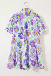 Vibrant floral mini dress with tiered ruffles, short puff sleeves, and a ruffled collar.