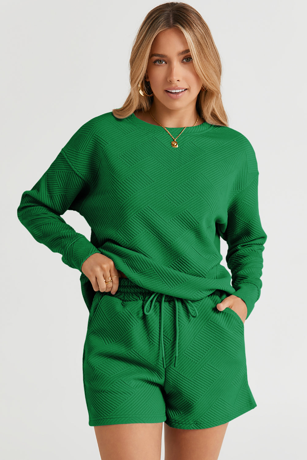Dark green textured geometric loungewear set with crewneck sweatshirt and drawstring shorts.