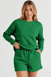 Dark green textured geometric loungewear set with crewneck sweatshirt and drawstring shorts.