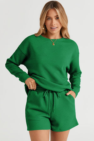 Dark green textured geometric loungewear set with crewneck sweatshirt and drawstring shorts.