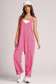 Pink relaxed fit jumpsuit with V-neck, sleeveless, and large front pockets.