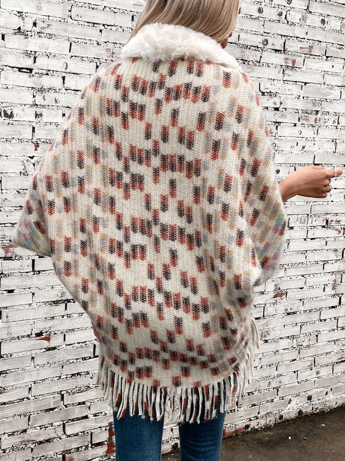 Textured plaid acrylic poncho with faux fur collar and fringe hem.