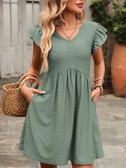 Bean Green A-line dress with ruffled sleeves, V-neck, and textured fabric.