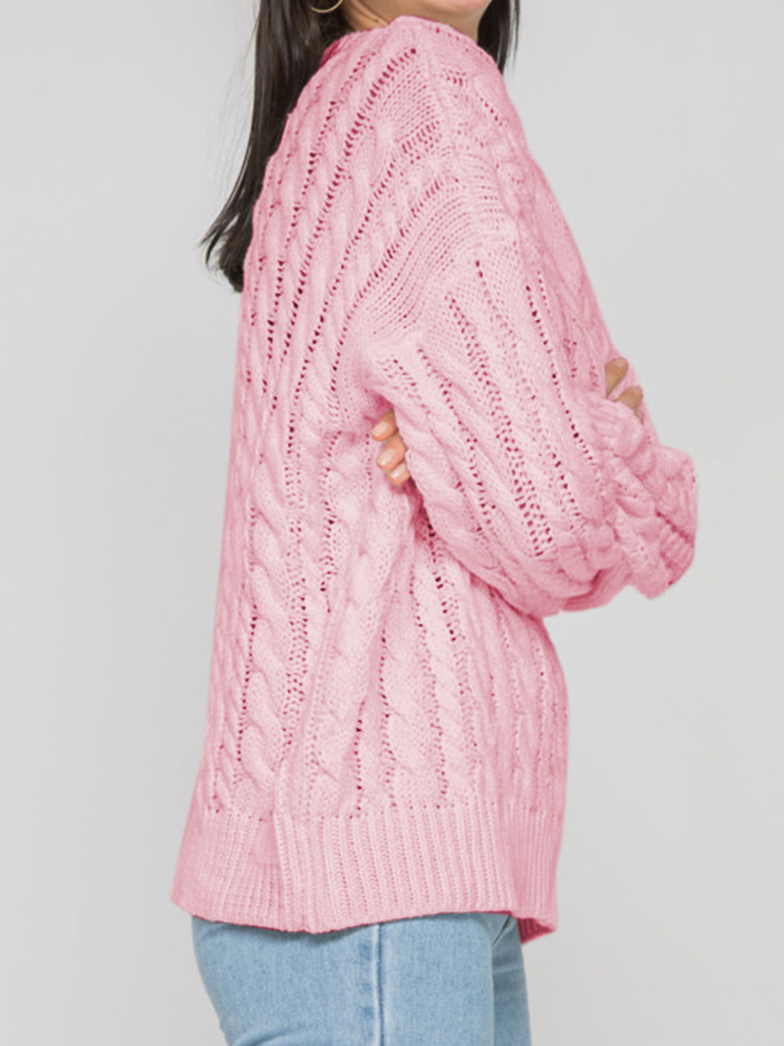 Cable knit openwork sweater in Carnation Pink acrylic with crew neck and long sleeves.