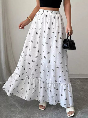 White maxi skirt with black bowknot print and ruffled hem.