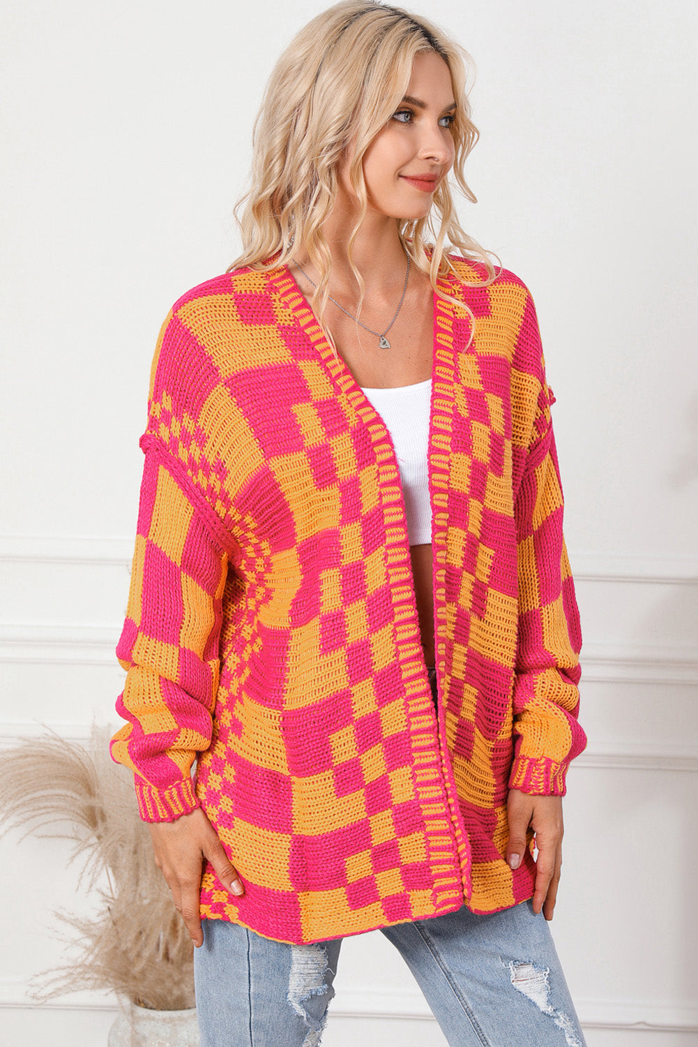 Checkerboard knit open cardigan in orange and pink acrylic with a relaxed fit.