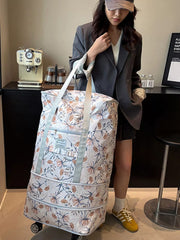 Charming floral rolling travel bag in white with a delicate botanical print, featuring wheels and handles for easy transport.