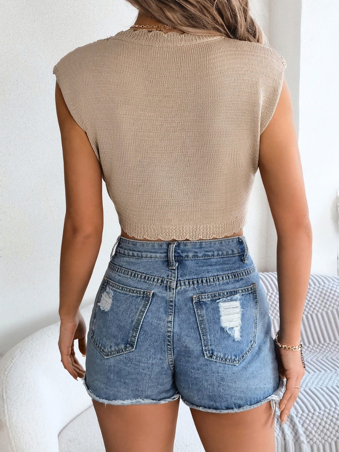Tan scalloped crochet crop top with distressed denim shorts