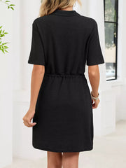 Black textured polo dress with short sleeves and adjustable drawstring waist.