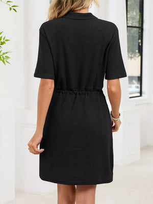 Black textured polo dress with short sleeves and adjustable drawstring waist.