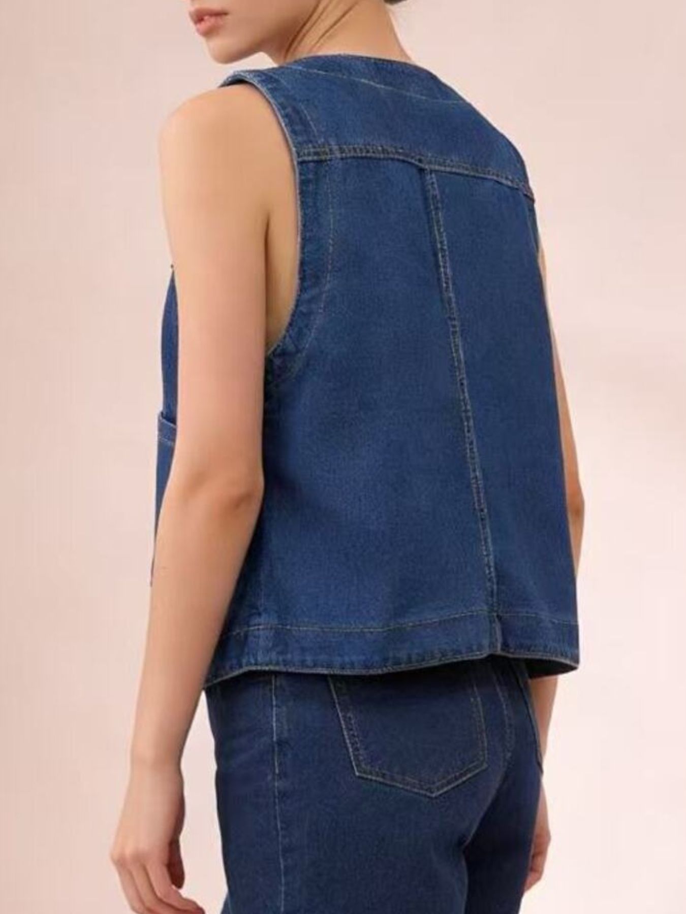 Plus size dark blue denim button-down vest with cropped length and brass buttons.