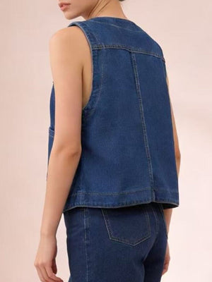 Plus size dark blue denim button-down vest with cropped length and brass buttons.