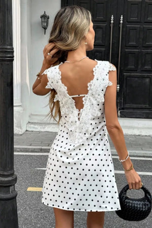 White polka dot mini dress with lace trim and open back detail.