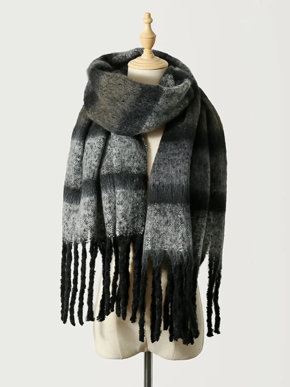 Ombre stripe scarf in black with fringe detail.
