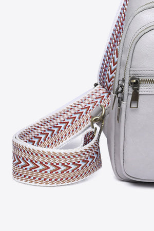 Geometric strap sling bag in Mid Gray with a colorful woven strap detail.