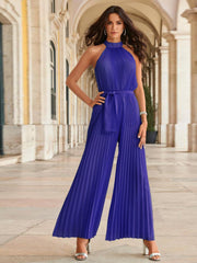 Light blue halter neck pleated palazzo jumpsuit with tie waist and wide legs.
