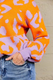 Colorblock leopard print acrylic sweater with balloon sleeves in orange and lavender.