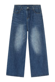 Pleated-front wide-leg denim trousers in peacock blue with a faded wash.