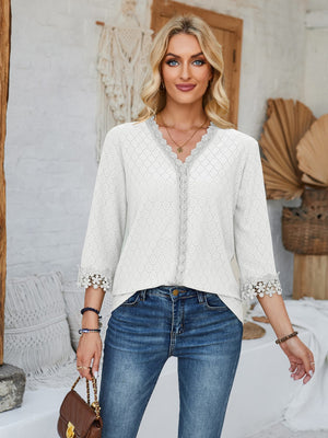 White eyelet blouse with V-neck and lace trim details