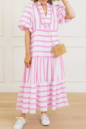 Maxi dress with pink and white stripes, notched neckline, puff sleeves, and tiered skirt.