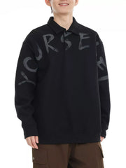 Black oversized polo sweatshirt with gray graphic letter print and button placket.