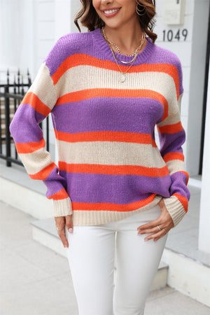 Crewneck knit sweater with bold purple, orange, and cream stripes.