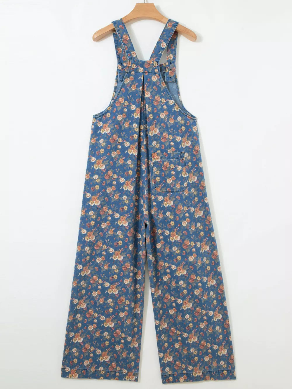 Floral denim overalls with adjustable straps and wide legs.