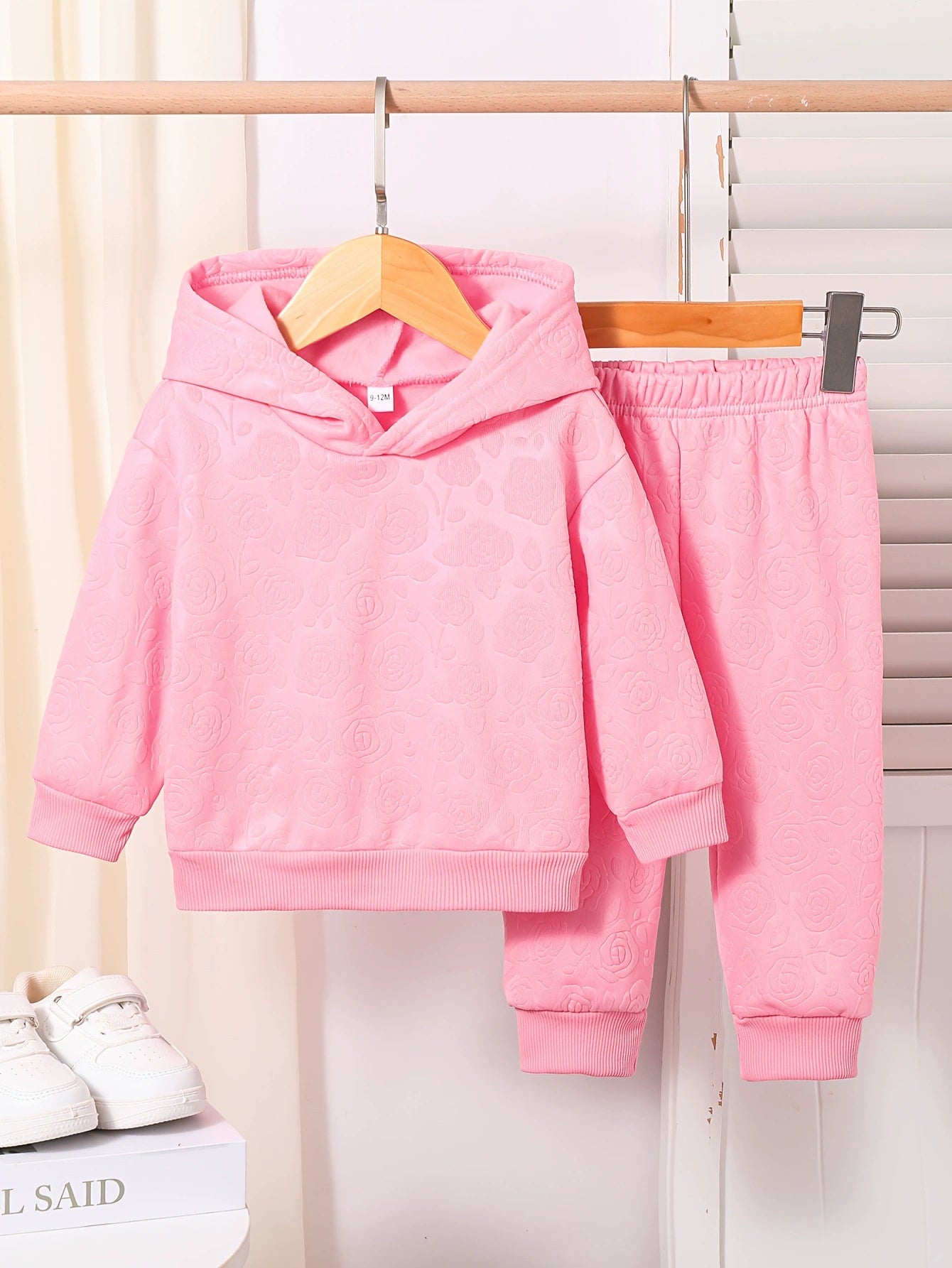 Pink embossed floral baby hoodie and pants set.
