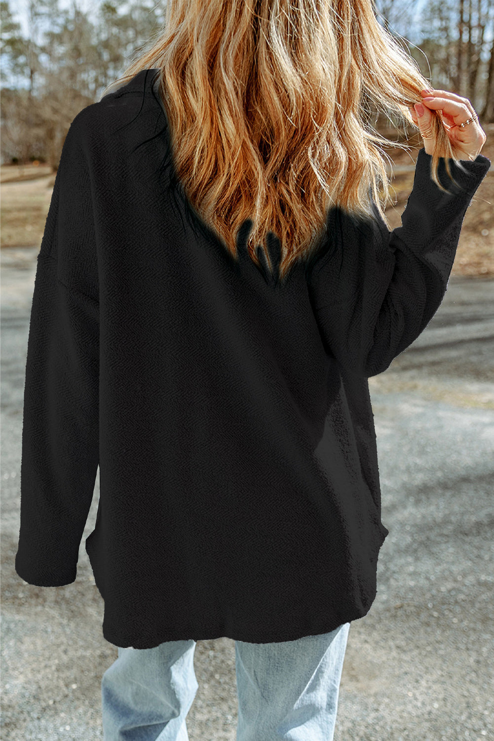 Black textured shacket with raw-edge detailing and pockets.