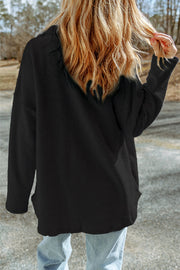 Black textured shacket with raw-edge detailing and pockets.