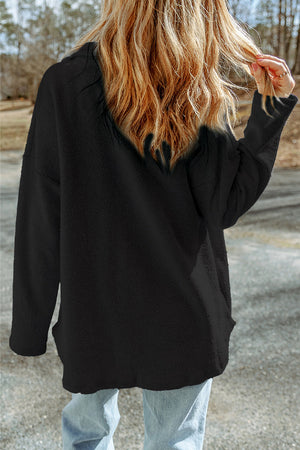 Black textured shacket with raw-edge detailing and pockets.