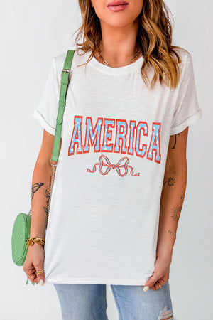 White graphic tee with "AMERICA" text and a bow detail.