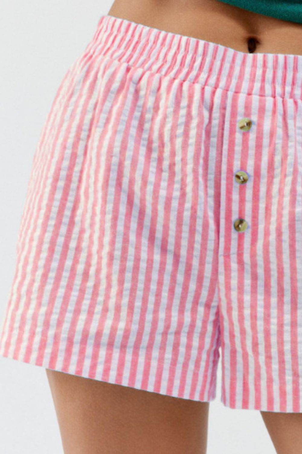 Pink and white seersucker boxer shorts with button fly and elastic waistband.