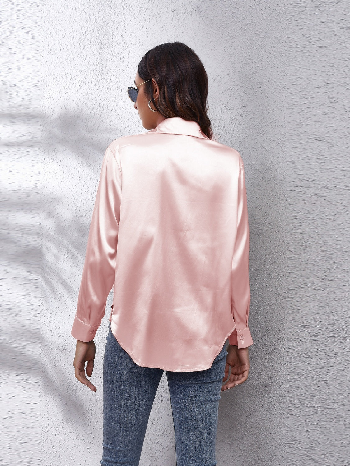 Silken button-down shirt in blush pink with a relaxed fit and button cuffs.
