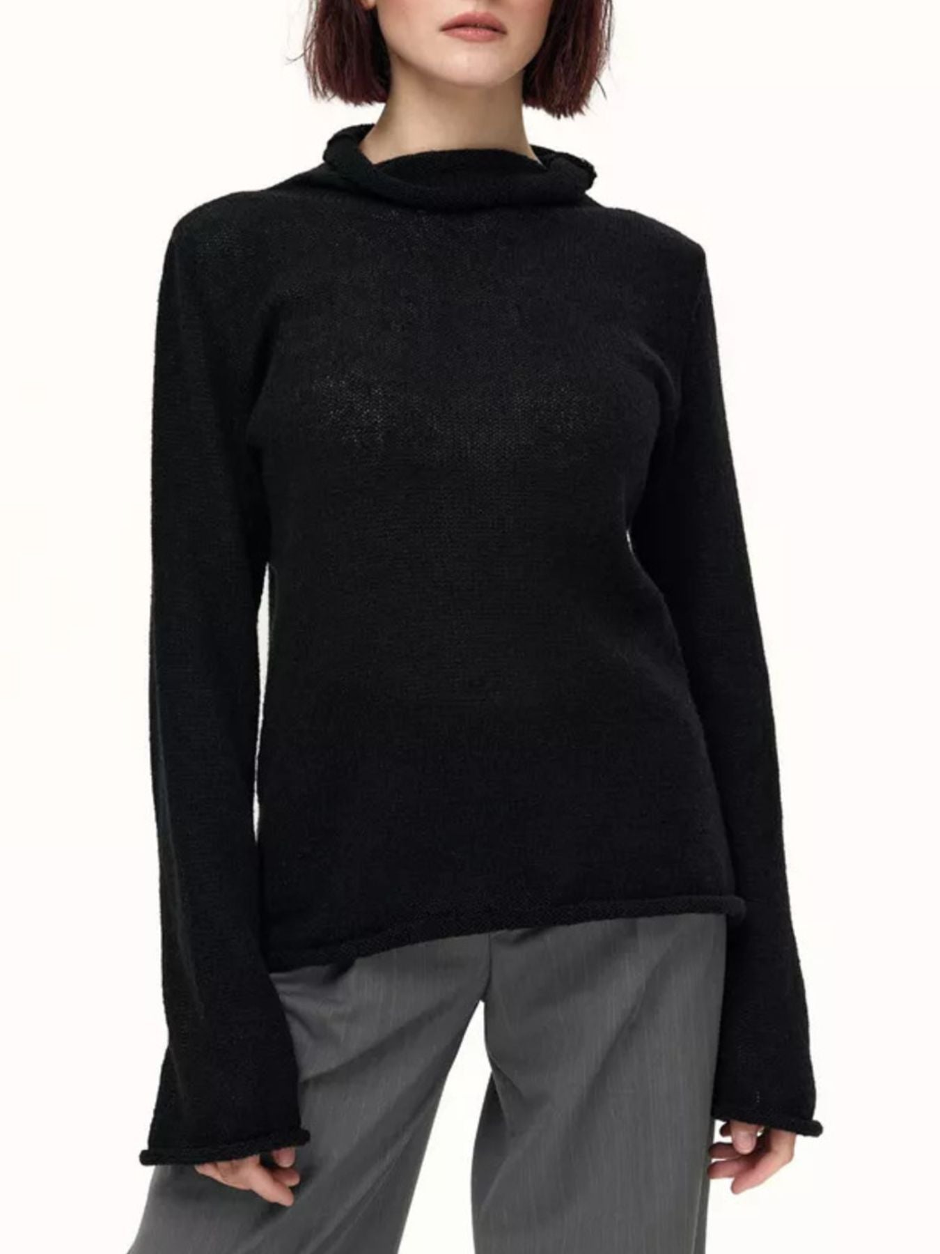 Black sheer mock neck knit sweater with draped neckline and raw hem detail.
