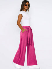 Hot Pink wide-leg flow pants with self-tie waist and pockets.