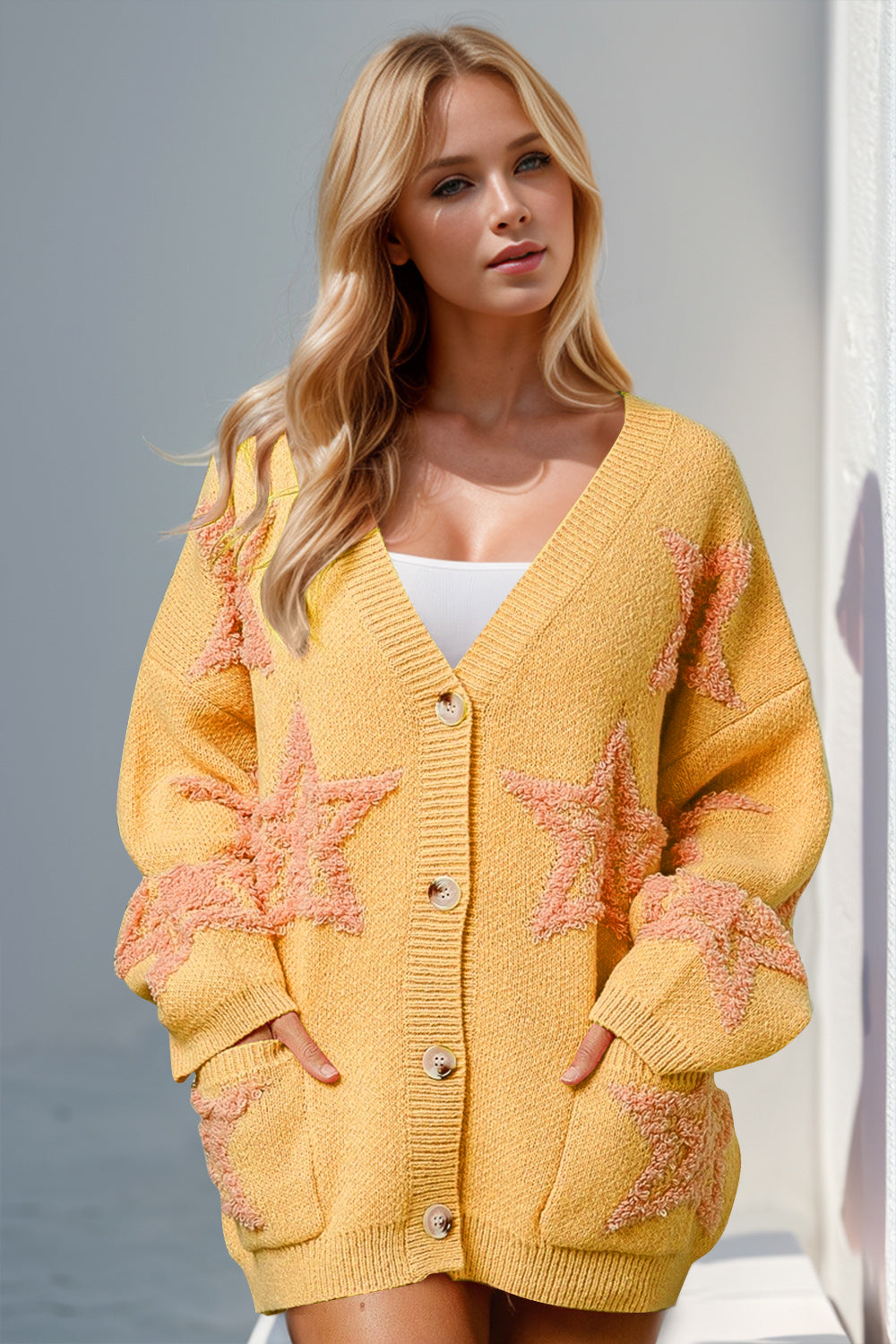 Yellow textured starburst pocket cardigan with button front and V-neck.